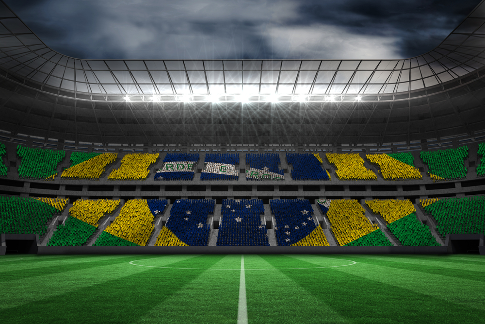 Digitally generated brazilian national flag against large football stadium