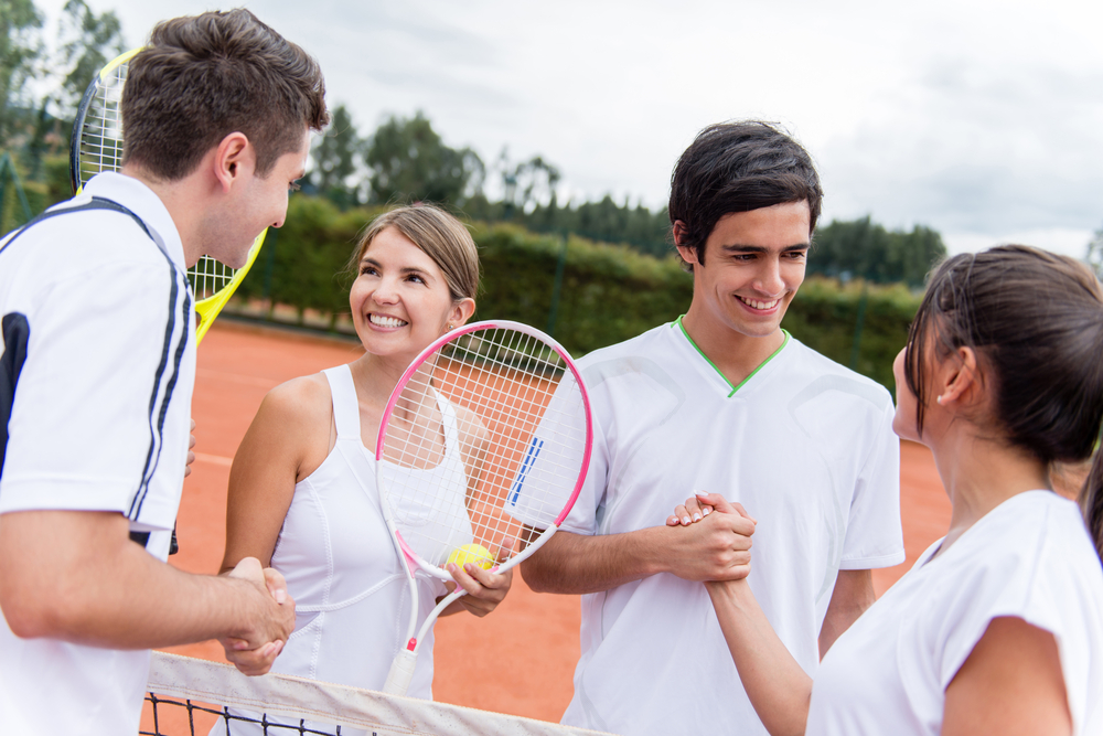 Group of tennis players giving a handshake after a match